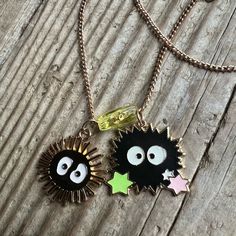 two necklaces with eyes and stars on them