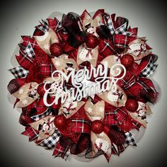 a red and white wreath with merry christmas written on it