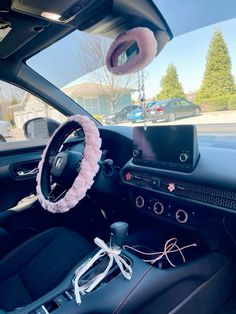 the interior of a car with a steering wheel cover and other accessories on it's dashboard