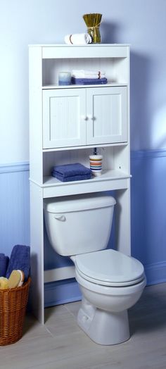 a white toilet sitting in a bathroom next to a shelf with drawers on top of it