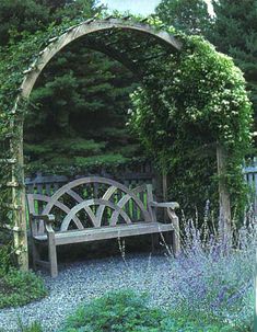 a wooden bench sitting in the middle of a garden