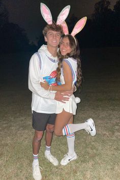 a man and woman in bunny ears hugging each other