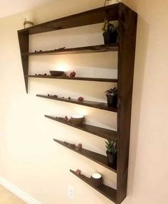 the shelves are made out of wood and have candles on them