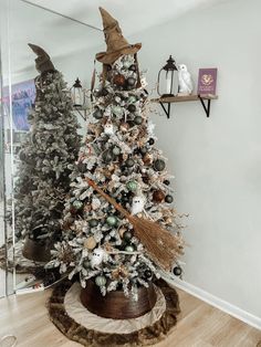 a decorated christmas tree in the corner of a room with other holiday decorations on display