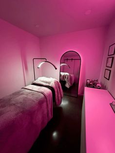 a bedroom with pink walls and black floors