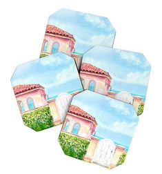 four coasters with an image of a building