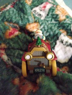 a christmas ornament hanging from the side of a blanket