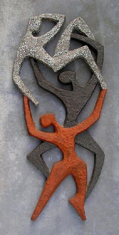 an orange and black sculpture on the ground with silver glittering around it's body