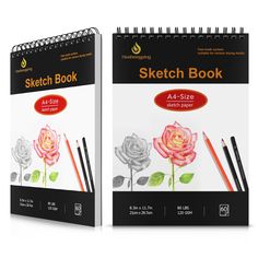 two spiral bound sketch books with pencils and roses on the front one is blank