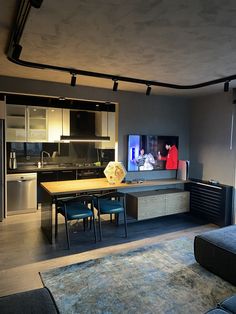 a living room filled with furniture and a flat screen tv mounted to the side of a wall