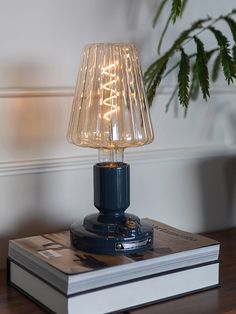 a table lamp sitting on top of a book