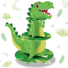 a paper model of a green dinosaur with its mouth open and teeth wide open, sitting on top of a three - tiered planter