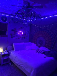 a bedroom with purple lights and a large bed