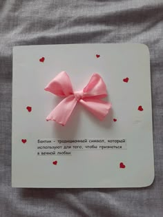 a card with a pink bow on it