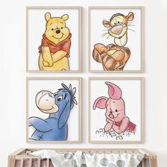 four winnie the pooh wall art prints hanging in a baby's crib