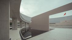 an empty building with a flag flying in the air next to some concrete pillars and walls