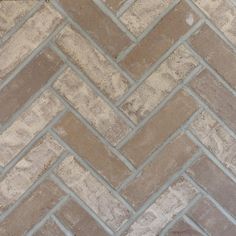 an image of a tile floor that looks like herringbones