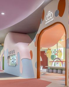 the interior of a children's playroom with colorful walls and flooring