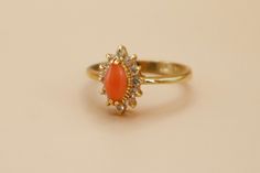 Vintage 18k Gold Electroplated CZ Semi Precious Coral Gemstone Ring Lovely vintage 18k gold plated ring featuring a marquise cut coral gemstone accented by smaller clear cubic zirconia stones. Absolutely perfect condition!  Hallmarked DO - Dolphin Ore Collection - New old stock.  Nickel Free.  Size 8 available.  ------------------------------------------------------- ♡ SHOP POLICIES ♡ ------------------------------------------------------- ♡ All items are vintage and have been pre-loved. Any not Gold Cluster Ring With Stone Setting, Dainty Gold Cluster Ring With Gemstone, Elegant Gold Cluster Ring With Stone Setting, Gold Cluster Ring With Stone Setting For Gift, Gold Cluster Ring With Stone Setting As Gift, Gold Cluster Ring With Stone Setting - Perfect Gift, Coral Rings, Coral Stone Ring, Coral Jewelry Vintage