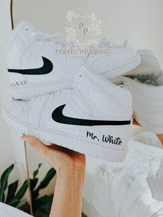 -This is a custom Groom's sneaker.  -Option 1 is only Name and date -Option 2 has painted outer 2 swooshes and names and dates. -Offers more designs and colors per request /check out my store/ -Open for custom requests. TURNAROUND TIME: -2 weeks to be crafted just for you -Shipping will take an additional 3-7 business days. -We offer FREE shipping within the US. -EXPEDITED service available Visit the link below for EXPEDITED SERVICE: https://perfctpairings.etsy.com/listing/1537883783 for PURCHAS Wedding Nikes Bride And Groom, White High-top Sneakers For Wedding, Custom Low-top Sneakers For Wedding, Custom White High-top Wedding Sneakers, Custom Low-top Wedding Sneakers, White High-top Wedding Sneakers, Sneaker Wedding, Groomsman Cake, Nike Air Jordan Mid