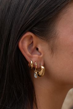 The Palma Earrings are a perfect match for anyone looking to switch up their stack. Beautifully designed to stand out from the classic square hoops, the organic shape makes these earrings art for the ears - one of a kind and timeless. 18k Gold Plated Stainless Steel Hypoallergenic, safe for sensitive ears Tarnish resistant Sold as a pair How To Style Multiple Earrings, Chunky Earring Stack, Earring Stack Gold, 3 Earrings Piercing In A Row, 3 Earring Stack, Earings 2024, Earring Stacks Gold, Gold Earrings Stack, Gold Ear Stack