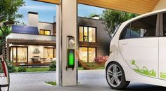 an electric car parked in front of a house