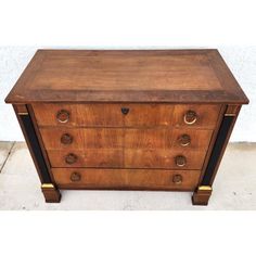 an antique chest of drawers with brass pulls and knobs on each drawer, in the manner of art deco