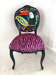 a zebra print chair sitting in front of a white wall