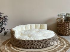 a dog bed is on the floor next to two baskets