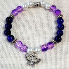 Pretty Butterfly Purple & White Glass 8mm Beaded Stretch Bracelet. Comes In Cellophane Packaging. Bundle & Save! Thanks For Stopping By! Posh On! Blue Beaded Bracelets Diy Jewelry, Glass Bead Crafts Jewellery, Glass Bead Jewelry Ideas, Glass Bracelet Ideas, Glass Bead Ideas, Glass Beaded Bracelets Ideas, Bracelet Ideas Glass Beads, Purple Bracelet Ideas, Glass Beads Bracelet Ideas