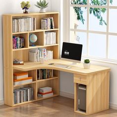 a computer desk sitting in front of a window with bookshelves on each side