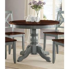 a dining room table with two chairs around it