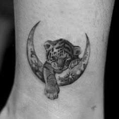 a tiger cub sitting on the moon tattoo