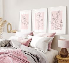 a bed with pink and white sheets, pillows and blankets