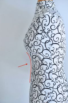 the back of a woman's dress with black and white swirls on it