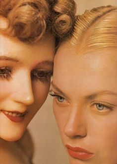 two women are posing for the camera with their hair pulled back and makeup applied to them