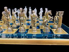 a gold and blue chess set with figures on it's board, including the king