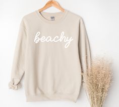 Whether you are taking a sunset stroll on the beach or lounging at home, this beachy sweatshirt will bring you pure comfort.  This unisex heavy blend crewneck is made from polyester and cotton, helping the design come out looking fresh and beautiful. The collar is ribbed knit, so it retains its shape even after washing. There are no itchy side seams on these sweaters. 50% Cotton 50% Polyester Medium-heavy fabric Unisex sizes (See size chart.) Sewn in label Available in 4 colors. Explore all Summ Trendy Summer Beach Sweatshirt, Trendy Beach Sweatshirt For Summer, Cotton Sweatshirt With Letter Print, Letter Print Sweatshirt For Beach Vacation, Cotton Sweatshirt For Beach Vacation, Cotton Sweatshirt For Beach Season Vacation, Beach Season Sweatshirt With Letter Print, Casual Sweatshirt For Beach Season, Casual Sweatshirt For Beach Season Leisure