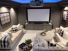 a living room with couches and a projector screen