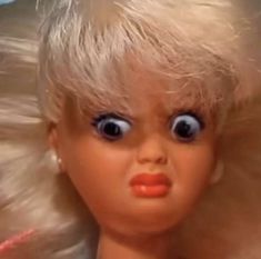 a doll with blonde hair and big blue eyes