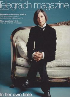 a man sitting on top of a white couch in front of a blue background with the cover of telegraph magazine