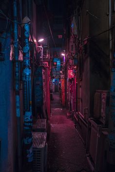 a narrow alleyway with neon lights in the dark