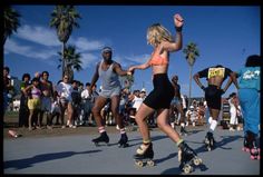 several people are skateboarding in front of a crowd