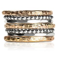 Introducing The Demi Stack, a set of seven unique and beautiful stacking rings that are perfect for making a bold statement. Made with mixed metals in gold fill and sterling silver, each ring features a different texture, from raw silk to mirror hammered. Mix and match them to create your own unique look. Whether you're dressing up or dressing down, these rings are sure to add a touch of edge and coolness to any outfit. USA sizes 4-12. Made with high quality materials, these rings are built to l Tarnish Remover, Stacking Ring Set, Gold Filled Ring, Ring Sizer, Different Textures, Silver Mirrors, Stacking Ring, Mixed Metals, Raw Silk