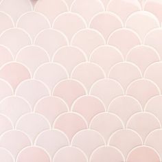 an abstract pink and white tile pattern with circles on the bottom, along with a heart shaped object