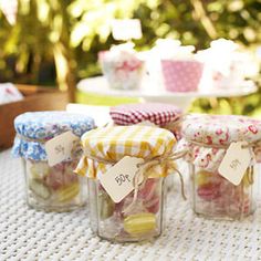 small jars filled with candy sitting on top of a table