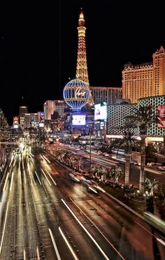 the las vegas strip is lit up at night with lights and buildings in the background