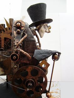 an old mechanical clock with a top hat on