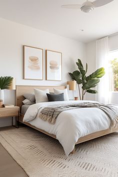 a bedroom with a bed and two plants in the corner