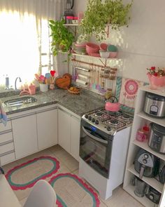 a kitchen filled with lots of counter space and decor on top of it's counters